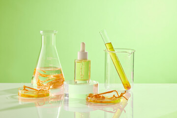 Against the green background, glass flask containing cordyceps and yellow liquid decorated with a serum bottle unbranded. Mockup scene for advertising cosmetic of cordyceps extract