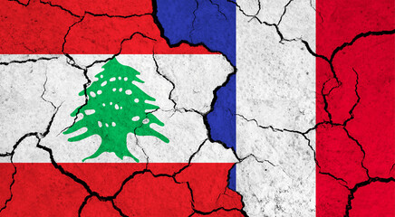 Flags of Lebanon and France on cracked surface - politics, relationship concept