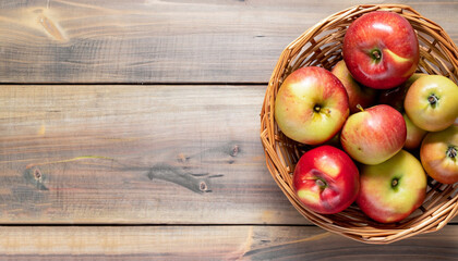 Ripe garden apple fruits in basket on wooden table. Top view flat lay with copy space