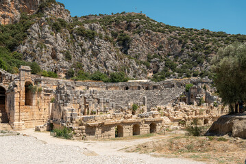 Fototapeta premium The ruins of the amphitheater and ancient rock tombs in the ancient city of Myra in Demre, Turkey