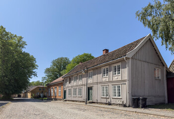 Fototapeta na wymiar Happy walking in old Fredrikstad on a great warm summer day, with many old buildings, Norway 