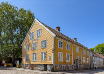 Happy walking in old Fredrikstad on a great warm summer day, with many old buildings, Norway	