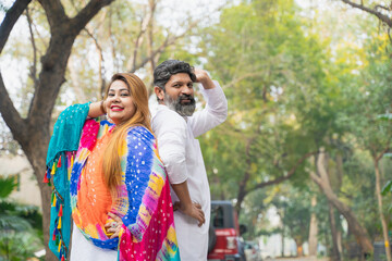Indian couple in traditional wear and giving happy expression. - obrazy, fototapety, plakaty