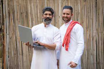 Technology concept. Two indian man using laptop - obrazy, fototapety, plakaty