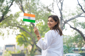 Indian woman waving national tri color flag