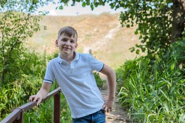 Portrait of a boy in nature looking at the camera with a smile. Space for text.