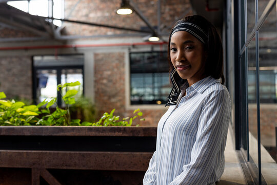 Portrait of a african american businesswoman standing at modern office, copy space