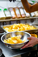 woman chef preparing potato chips in kitchen