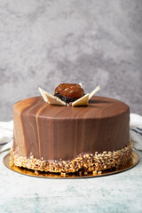 Chocolate cake. Chocolate, chestnut and pistachio birthday cake on gray background