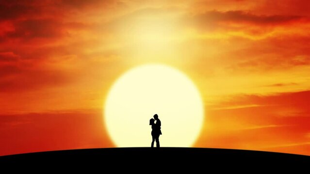Silhouette of romantic couple standing on the hill and kissing