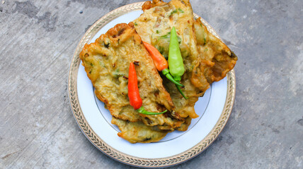 fried tempe or mendoan served on a plate with cayenne pepper
