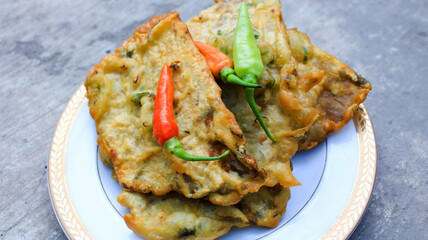 fried tempe or mendoan served on a plate with cayenne pepper