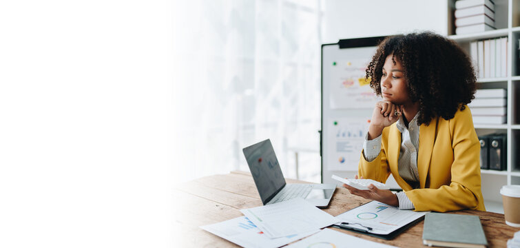 Young asian female work with financial papers at home count on calculator before paying taxes receipts online, planning budget glad to find chance for economy saving money, audit concepts.