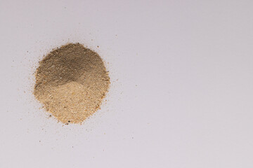 Close up of heap of sand and copy space on white background