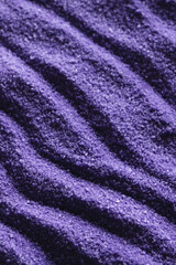 Fototapeta na wymiar Close up of pattern of purple sand and copy space background