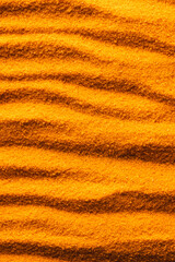 Fototapeta na wymiar Close up of pattern of orange sand and copy space background