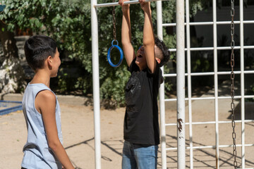 Obraz premium best friends in Uzbekistan enjoying there summer vacation in an outdoor park playing games and the different expressions on their faces while playing in hot street make a friendship day special 