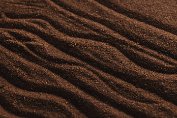 Close up of pattern of brown sand and copy space background