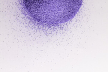 Close up of heap of purple sand and copy space on white background