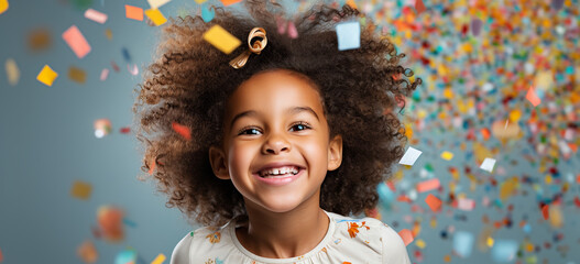 portrait of a happy child with colorful confetti