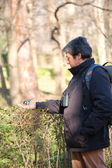 A Great tit, Parus major, eating peanuts from a woman hand in a park in Madrid, Spain.