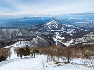 Steep ski slope with the view of snowy peaks (Ryuo, Nagano, Japan)