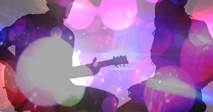 Animation of colourful spots moving over silhouette of man and women playing guitar and drums