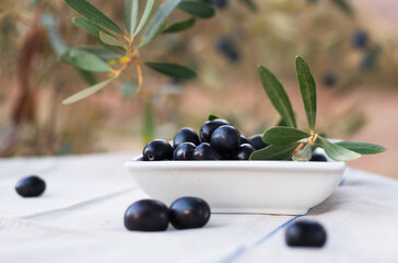 black ripe olives on plate on table in olive garden