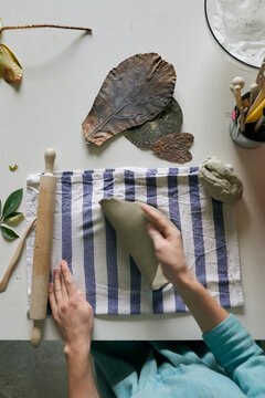 A photo of young woman working with clay process
