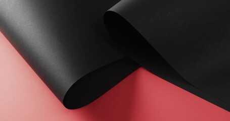 Close up of rolls of black paper and copy space on red background - Powered by Adobe