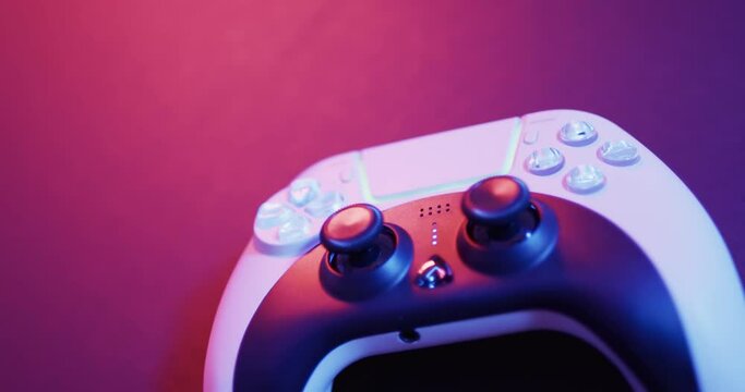 Video of close up of video game pad controller with copy space on neon background