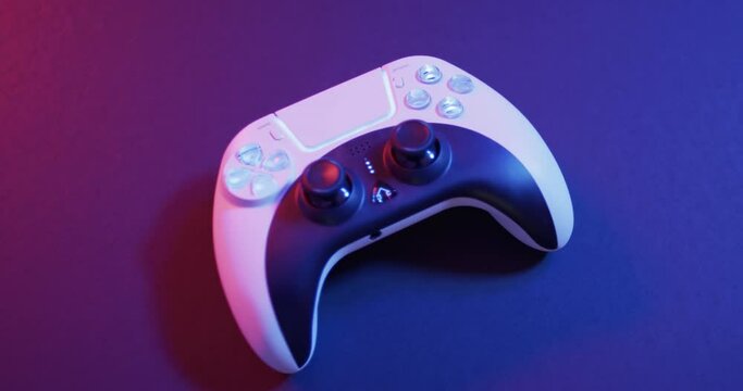 Video of close up of video game pad controller with copy space on neon background