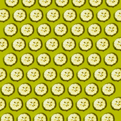 Fresh lemon slices against green background forming a beautiful wallpaper texture pattern background.