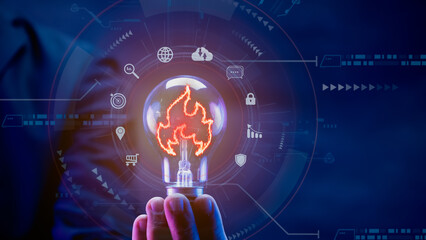 Businessman hand showing glowing light bulb with fire icon or sign for creative thinking idea concept and future innovative technology. Creative, inspiration, imagination, learning and education.