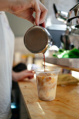 Barista preparing iced latte