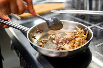 Chef cook hand cooking food at the restaurant kitchen