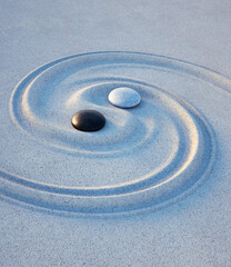 Yin Yang symbol. Motive made of stones and lines in the sand - 3D illustration