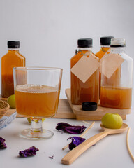 Fresh green amla or indian gooseberry fruits with gooseberry juice, healthy diet on white table. 