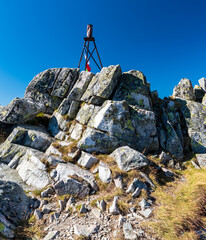 Triangulation station on rocky hill summit - Maly Svistovy stit in High Tatras mountains in Slovakia