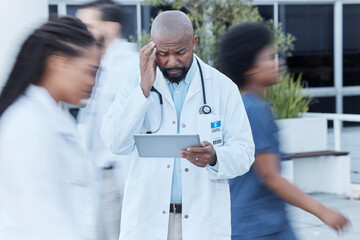 Tablet, black man and doctor with stress in busy hospital, fatigue or burnout. Tech, medical...
