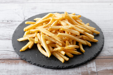 Fried potatoes, french fries on wooden table