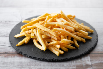 Fried potatoes, french fries on wooden table