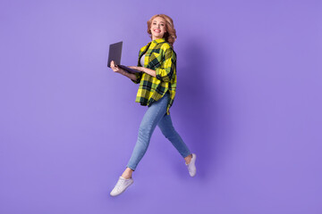 Fototapeta na wymiar Full length legs photo of girl worker running with laptop comfortable device for studying while going isolated on violet color background