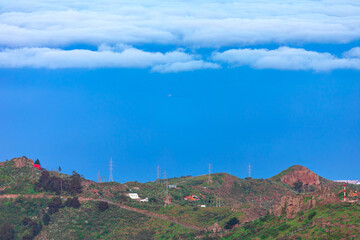 Mountain landscape with white clouds and blue sky