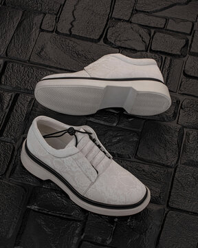 Modern street shoes stand stone on stone against a gray background