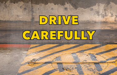 Drive carefully concept written on the roadway