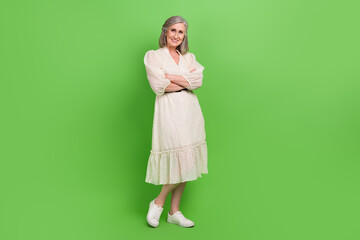 Full body photo of lovely retired lady crossed arms shopping advertising dressed stylish white outfit isolated on green color background