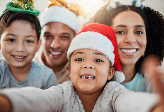 Parents, kids and christmas selfie in family home, smile and excited for event, culture and celebration together. Mom, dad and young children with xmas memory, photography or profile picture on blog