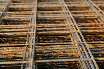 Stack of welded wire mesh, WWM, ready to be installed within a sidewalk concrete form. 