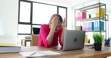 Confused young woman having problem with blocked credit card in office. Refused to make insecure online payment using laptop at work
